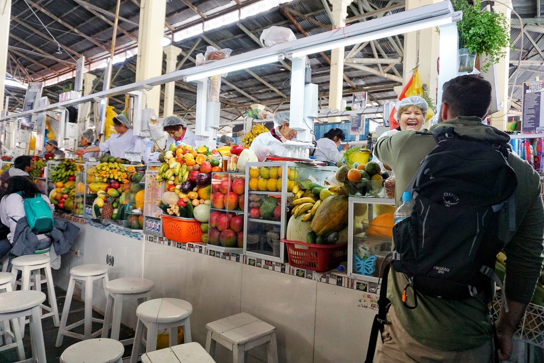 Ordering fresh juice at the food stalls inside San Pedro Market, Cusco. 