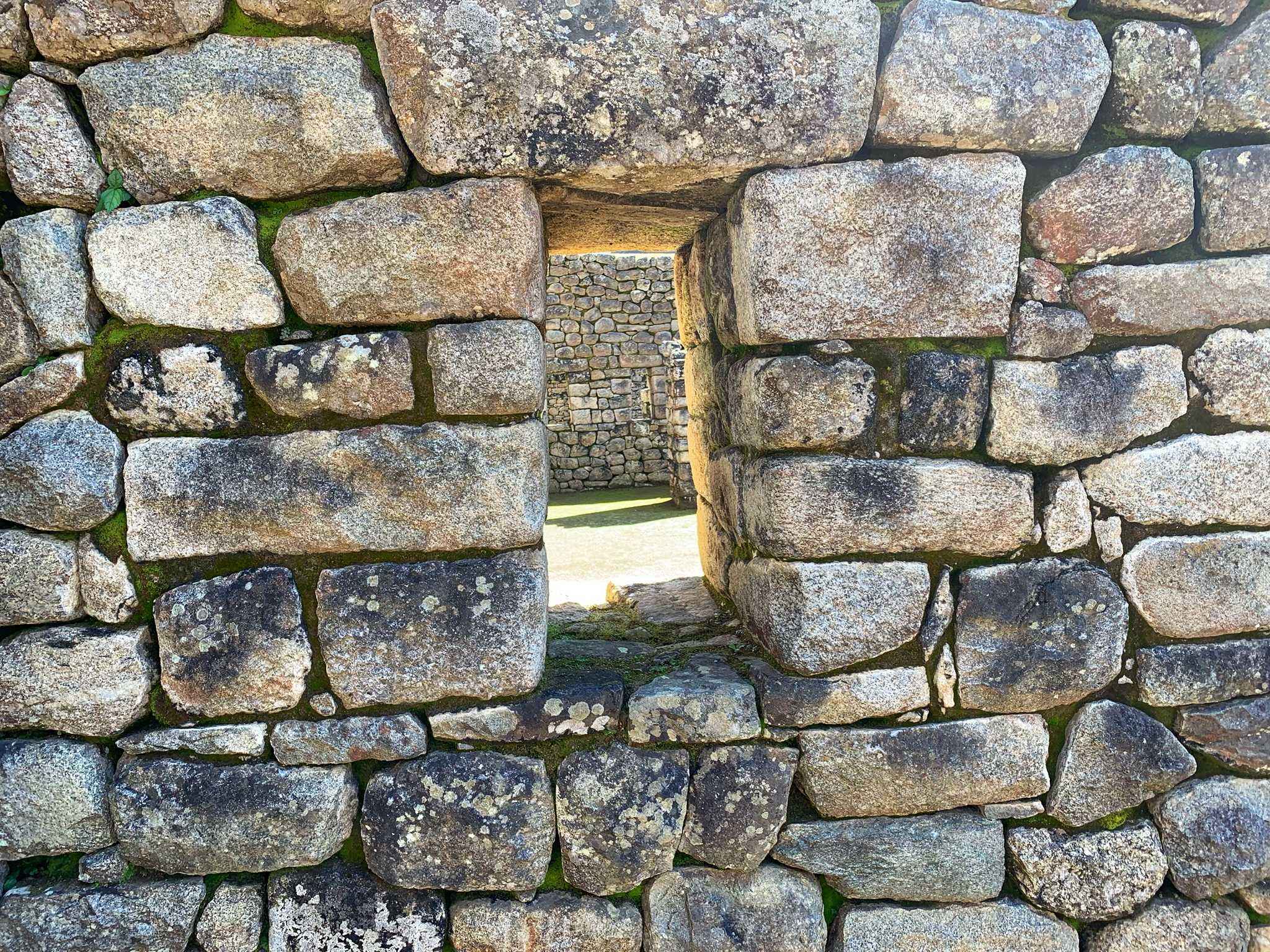 Looking through stone windows during the Machu Picchu tour
