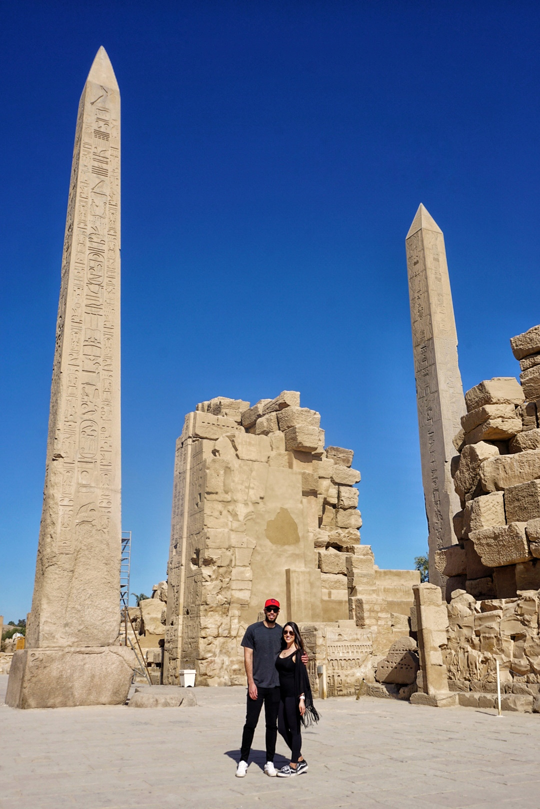 Standing in front of 2 obelisks at Karnak Temple