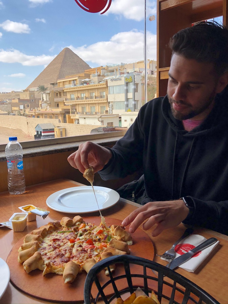 Eating at a nearby Pizza Hut with a view of the Pyramids in the background