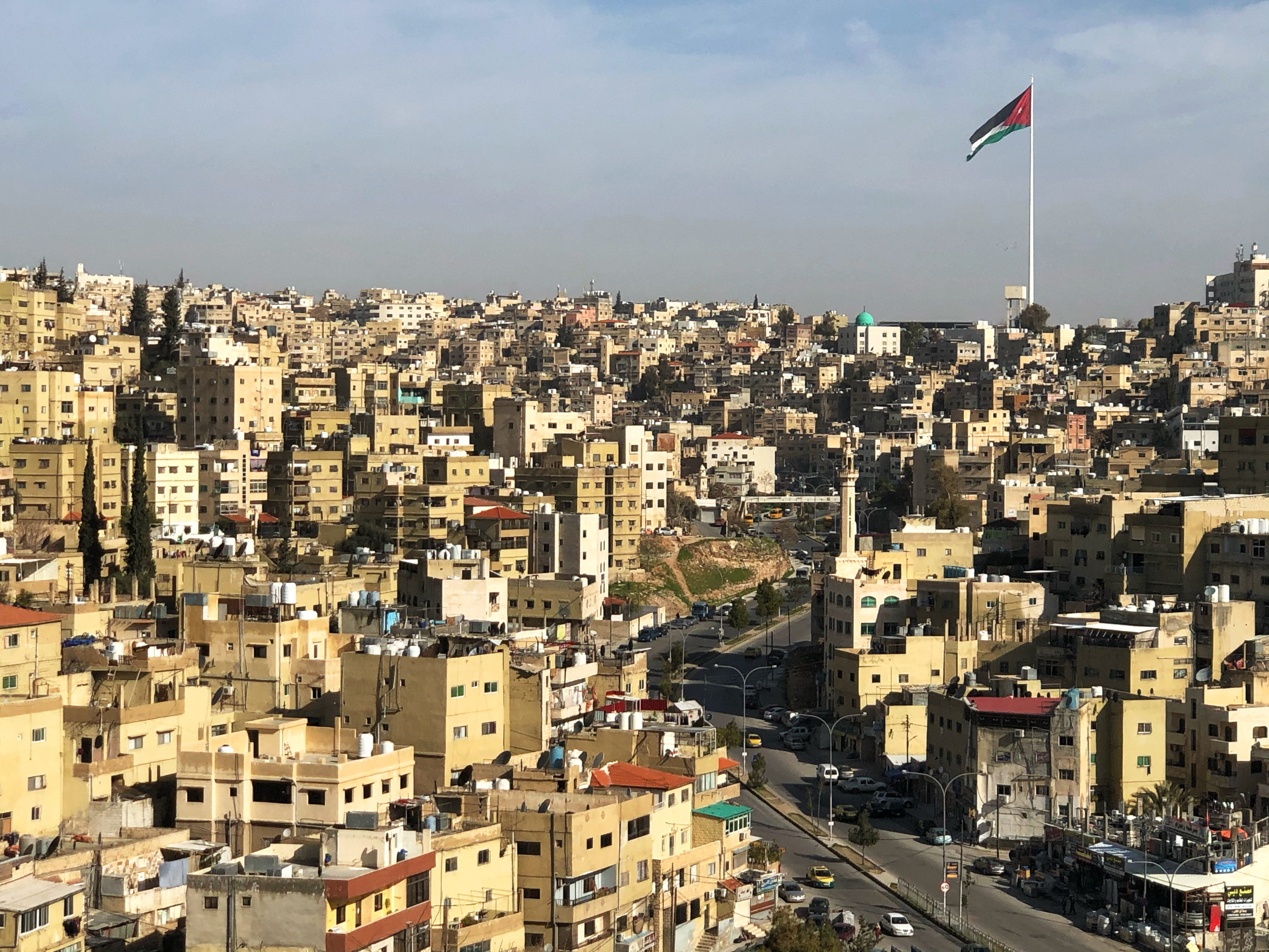 A view of the Jordan flag flying over the city of Amman