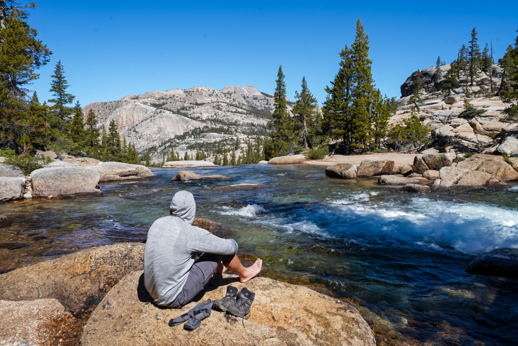 Relaxing on a rock overlooking the river along the Glen Aulin trail, Yosemite
